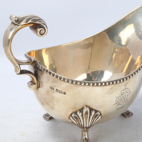 1767 - A late Victorian silver sauce boat, Mappin & Webb, Sheffield 1897, with beaded rim, scrolled acanthu... 