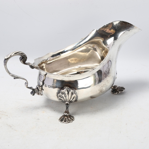 1768 - A George V silver sauce boat, Barker Brothers, Chester 1919, scalloped rim with scrolled acanthus le... 