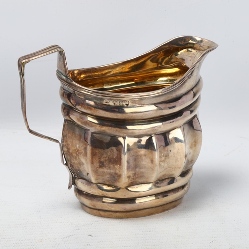 1771 - A George III silver cream jug, no maker, London 1805, waisted form, with reeded rim and gilt interio... 