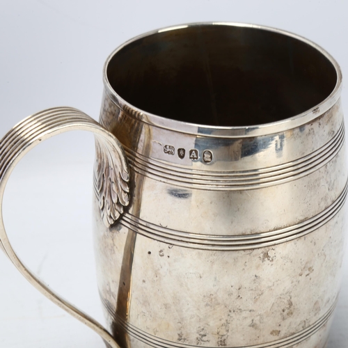 1775 - A George III silver barrel pint mug, with reeded decoration and acanthus leaf reeded handle, indisti... 