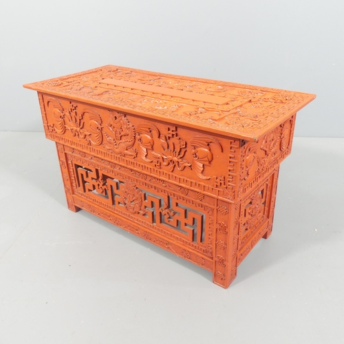 2033 - A modern Chinese red lacquered box on stand, with all-over applied carved and pierced decoration. 72... 