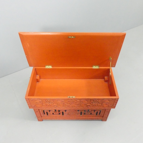 2033 - A modern Chinese red lacquered box on stand, with all-over applied carved and pierced decoration. 72... 