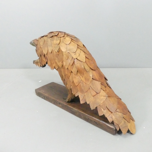 2054 - CLIVE FREDRIKSSON - A hand carved sculpture, study of a pangolin. 85x50x25cm.