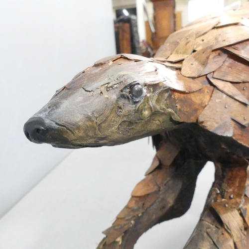 2054 - CLIVE FREDRIKSSON - A hand carved sculpture, study of a pangolin. 85x50x25cm.