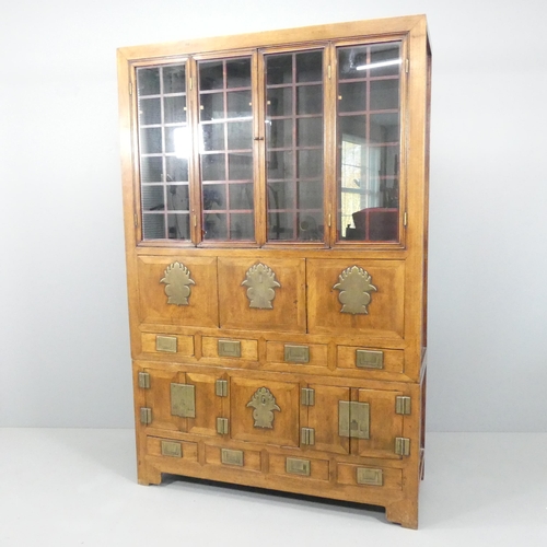 2059 - A Korean two-section cabinet, with two bi-fold doors, eight drawers, two fall-front doors and two cu... 