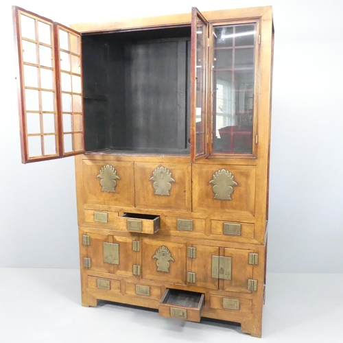 2059 - A Korean two-section cabinet, with two bi-fold doors, eight drawers, two fall-front doors and two cu... 