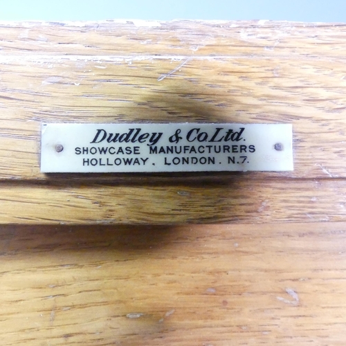 2063 - An early/mid 20th century oak haberdashery shop cabinet, made by Dudley & Co. Ltd., Showcase Manufac... 