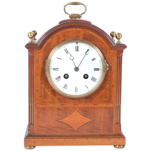 182 - An Edwardian mahogany and satinwood-banded arch-top mantel clock, white enamel dial and Roman numera... 