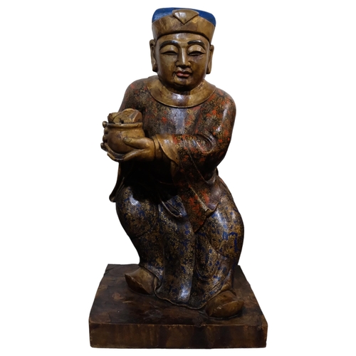 155 - A large Chinese carved wood figure of a merchant, with gilded chinoiserie decoration, on rectangular... 