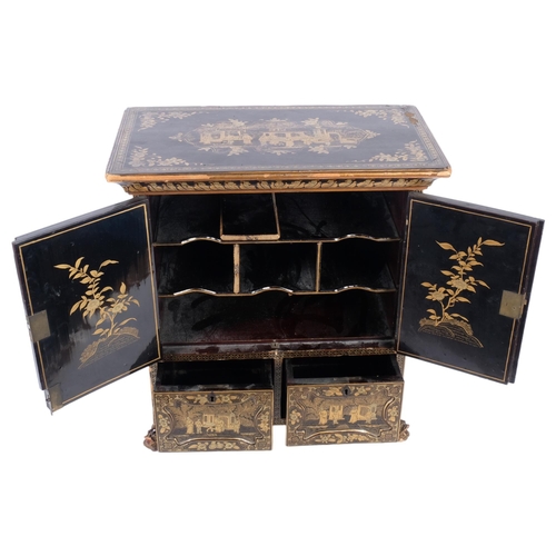 156 - A Chinese black lacquered table-top cabinet, with 2 panel doors revealing a cubby hole fitted interi... 