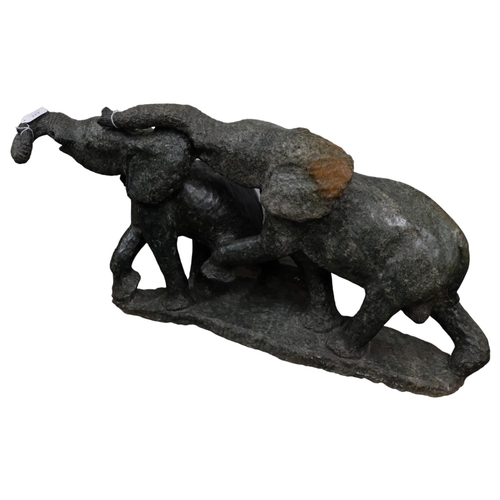 173 - An African green serpentine marble carved sculpture of 2 elephants, length approx 83cm