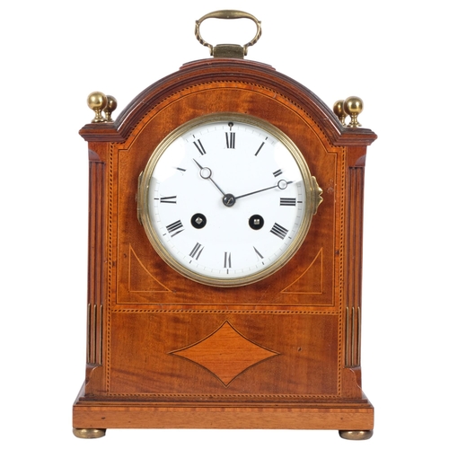 182 - An Edwardian mahogany and satinwood-banded arch-top mantel clock, white enamel dial and Roman numera... 