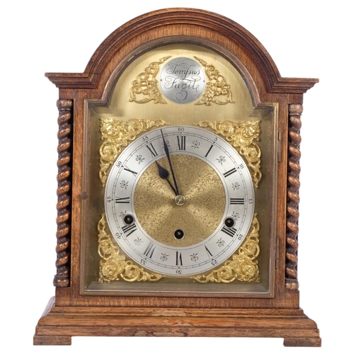 183 - A 1920s oak-cased arch-top bracket clock, brass arch-top dial, silver chapter ring and Roman numeral... 