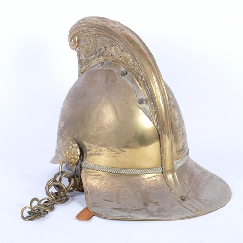 186 - A brass fireman's helmet, with leather lining and original strap