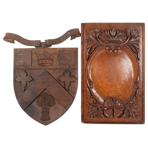 187 - An oak carved coat of arms for Clifton College, L39cm, and an Antique oak panel with applied decorat... 