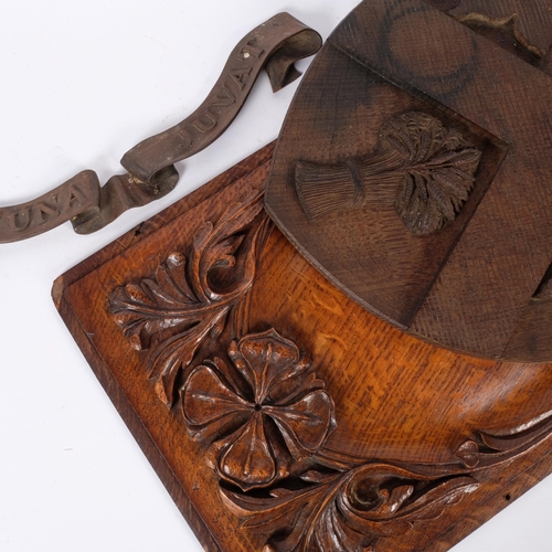 187 - An oak carved coat of arms for Clifton College, L39cm, and an Antique oak panel with applied decorat... 