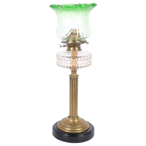 188 - A Victorian brass oil lamp, with shaped green glass shade and glass font, brass fluted column and bl... 