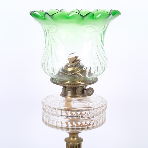 188 - A Victorian brass oil lamp, with shaped green glass shade and glass font, brass fluted column and bl... 