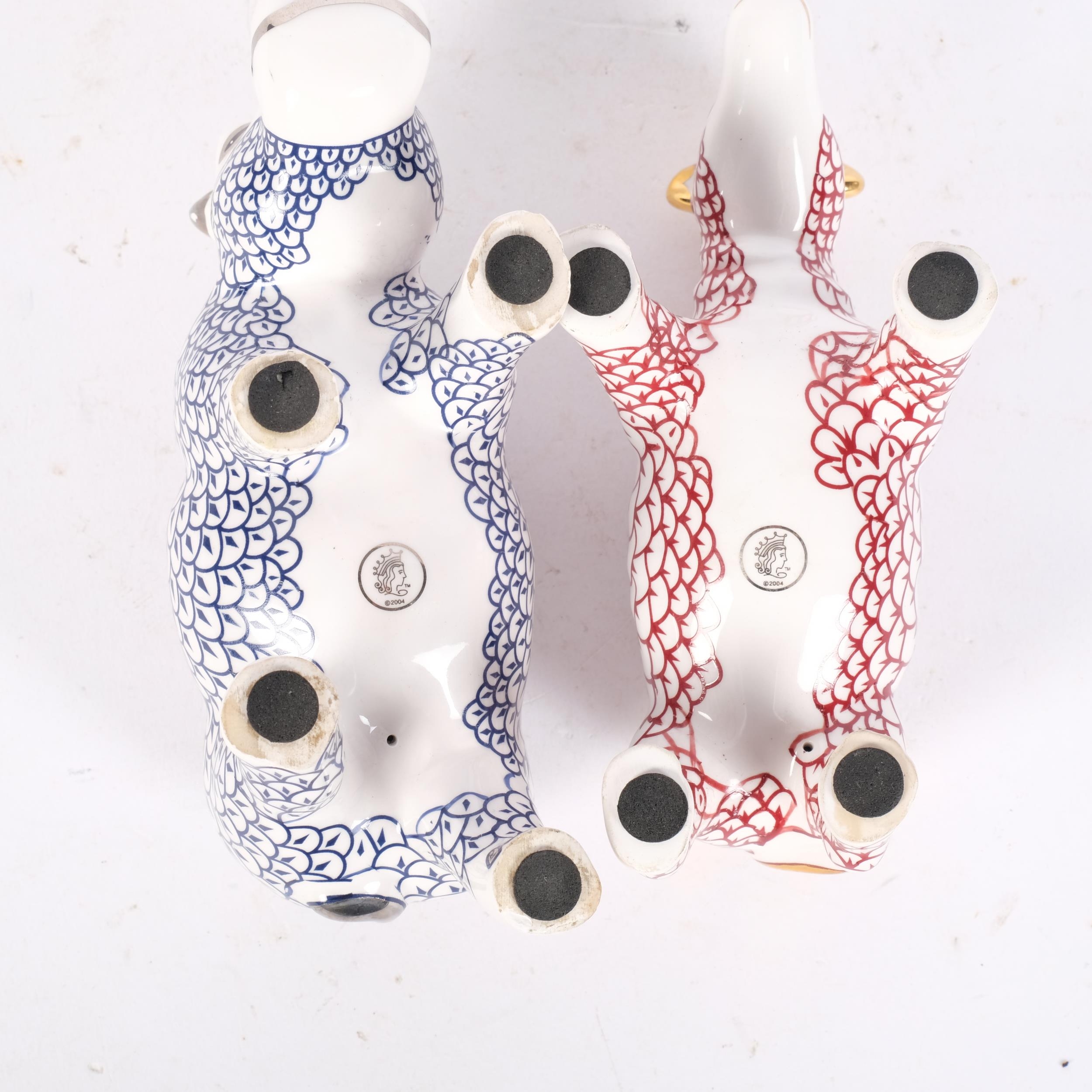 A porcelain hippopotamus and a rhinoceros, with stamp dated 2004 to the