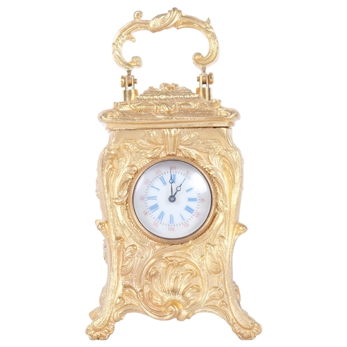 321 - An ornate reproduction miniature gilt-metal carriage clock, with swing handle, height not including ... 