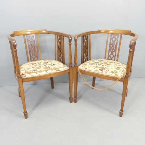 2698 - A pair of Edwardian mahogany and upholstered tub chairs, with pierced decoration and spade feet, and... 