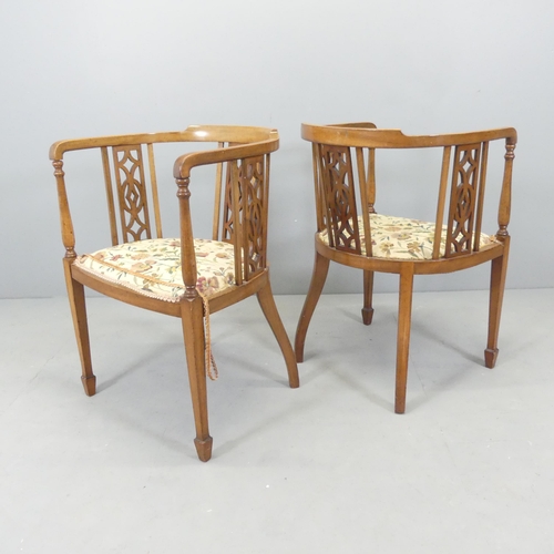 2698 - A pair of Edwardian mahogany and upholstered tub chairs, with pierced decoration and spade feet, and... 