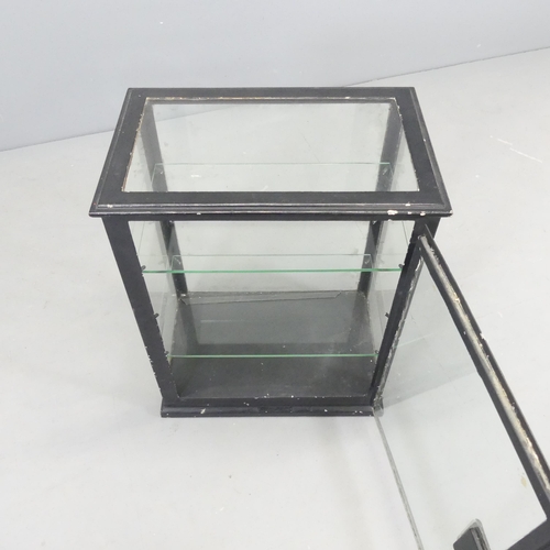 A vintage painted metal medicine with glazed panelled door and sides and two glass shelves.