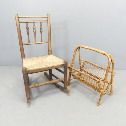 2693 - A bamboo magazine rack, and an antique spindle back rush-seated rocking chair. (2)