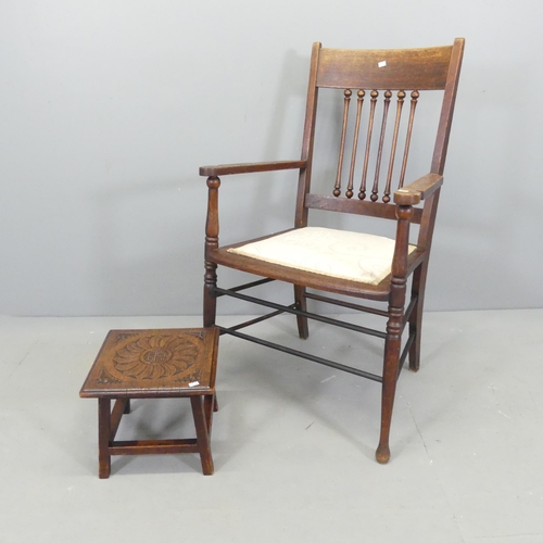 2696 - A Victorian Arts & Crafts oak open arm chair, and a carved oak footstool (2).