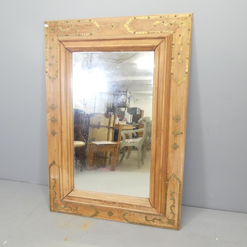 2702 - An Anglo-Indian design teak and brass mounted rectangular wall mirror. 90x129cm.