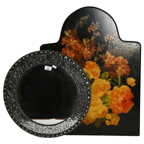 1002 - A modern circular wall mirror, and an ebonised fire screen with floral decoupage decoration, H72cm