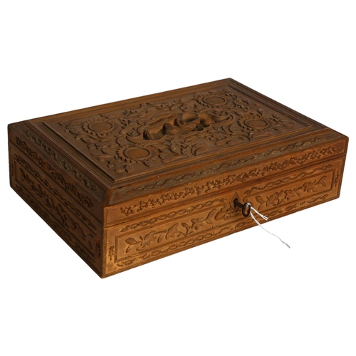 1015 - A Chinese sandalwood carved and engraved box, with relief decorated lid, silk lined, and key, W33cm