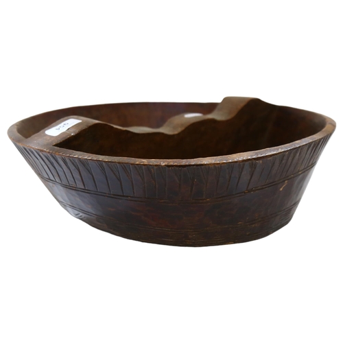 954 - An African carved wooden bowl with sectional divider, diameter 40cm