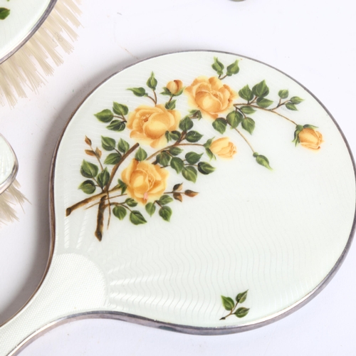 1103 - A white and floral enamelled dressing table brush and mirror set, a boxed silver-backed brush, etc