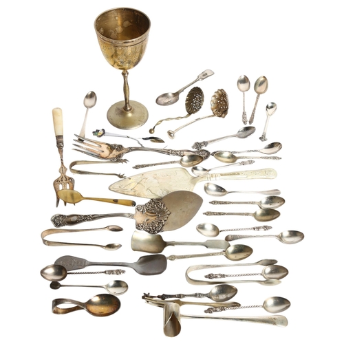 1104 - A tray of mixed spoons, cake slice, tea strainer, pickle forks, and an engraved goblet