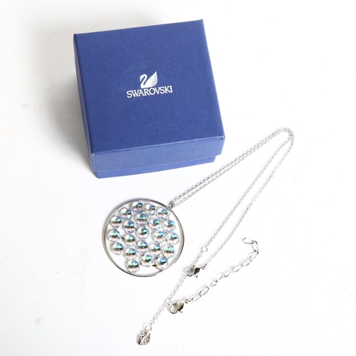 1158 - SWAROVSKI - a palladium plated circular disc pendant and chain, boxed