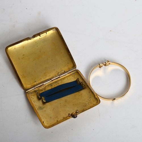 1197 - A gold plated cigarette case with a stone set button, and a gold plated engraved bangle