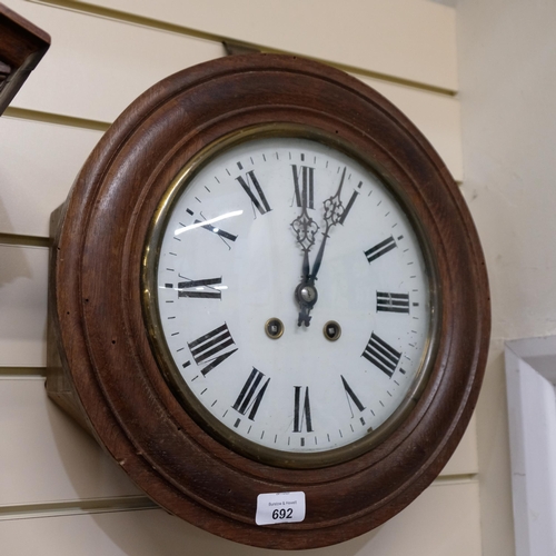 692 - An oak-cased dial wall clock, 8-day movement, painted dial, W37cm, complete with pendulum but no key