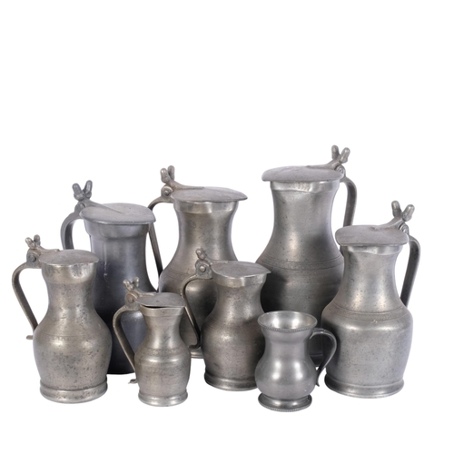 761 - A group of lidded pewter jugs, tallest 26.5cm, and a pewter mug