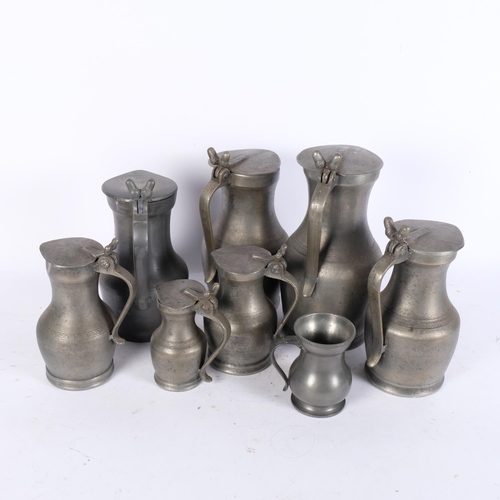 761 - A group of lidded pewter jugs, tallest 26.5cm, and a pewter mug