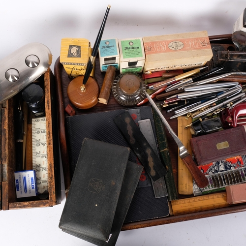 767 - An oak tray with a large quantity of desk items, including fountain pens, hole puncher, rulers, ink ... 