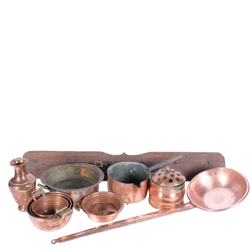 776 - A long-handled copper pan, 77cm, a copper milk pan, and coat hooks, copper pots, colander etc