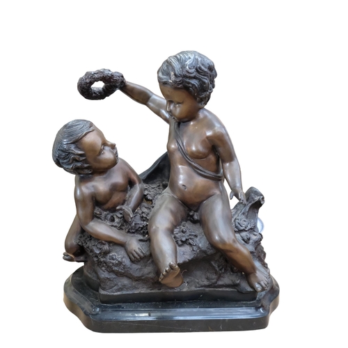 778 - A patinated spelter group of 2 cherubs, on a shaped marble base, H50cm