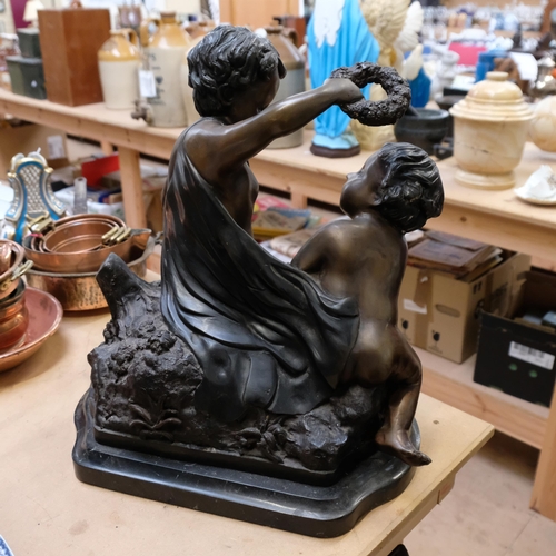 778 - A patinated spelter group of 2 cherubs, on a shaped marble base, H50cm