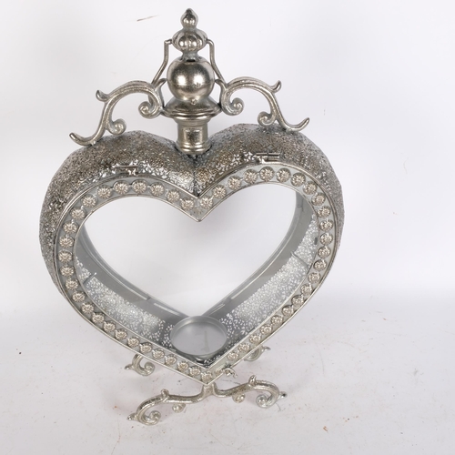 786 - A candle lantern in glazed silvered metal heart-shape frame, H50cm