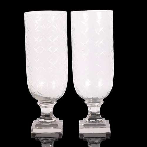 789 - A pair of cut glass hurricane lanterns, on square plinths, H34cm