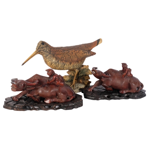 831 - Capodimonte porcelain snipe, and 2 Chinese carved wood water buffalos on stands, L21cm