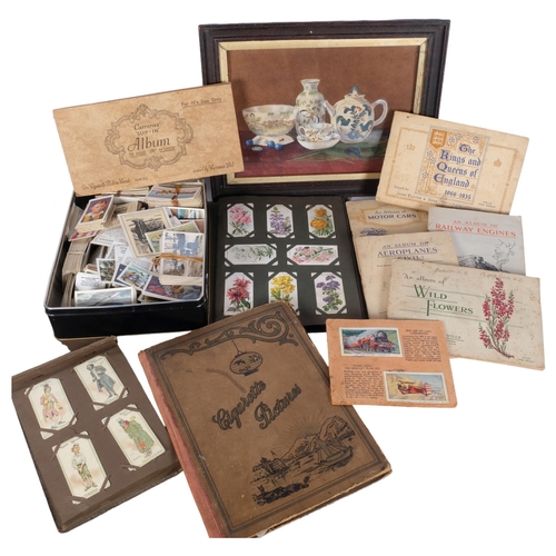 832 - A group of Vintage cigarette cards, various albums and loose cards, and a small framed still life wa... 