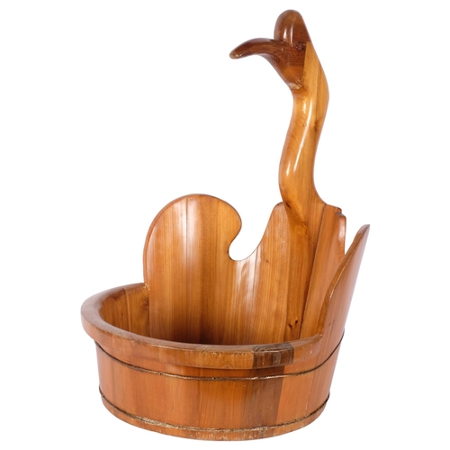 867 - A large polished pine fruit bowl, surmounted by a duck, H65cm