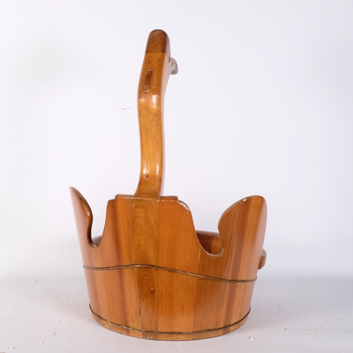 867 - A large polished pine fruit bowl, surmounted by a duck, H65cm